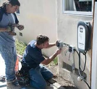 Electricians fixing junction box